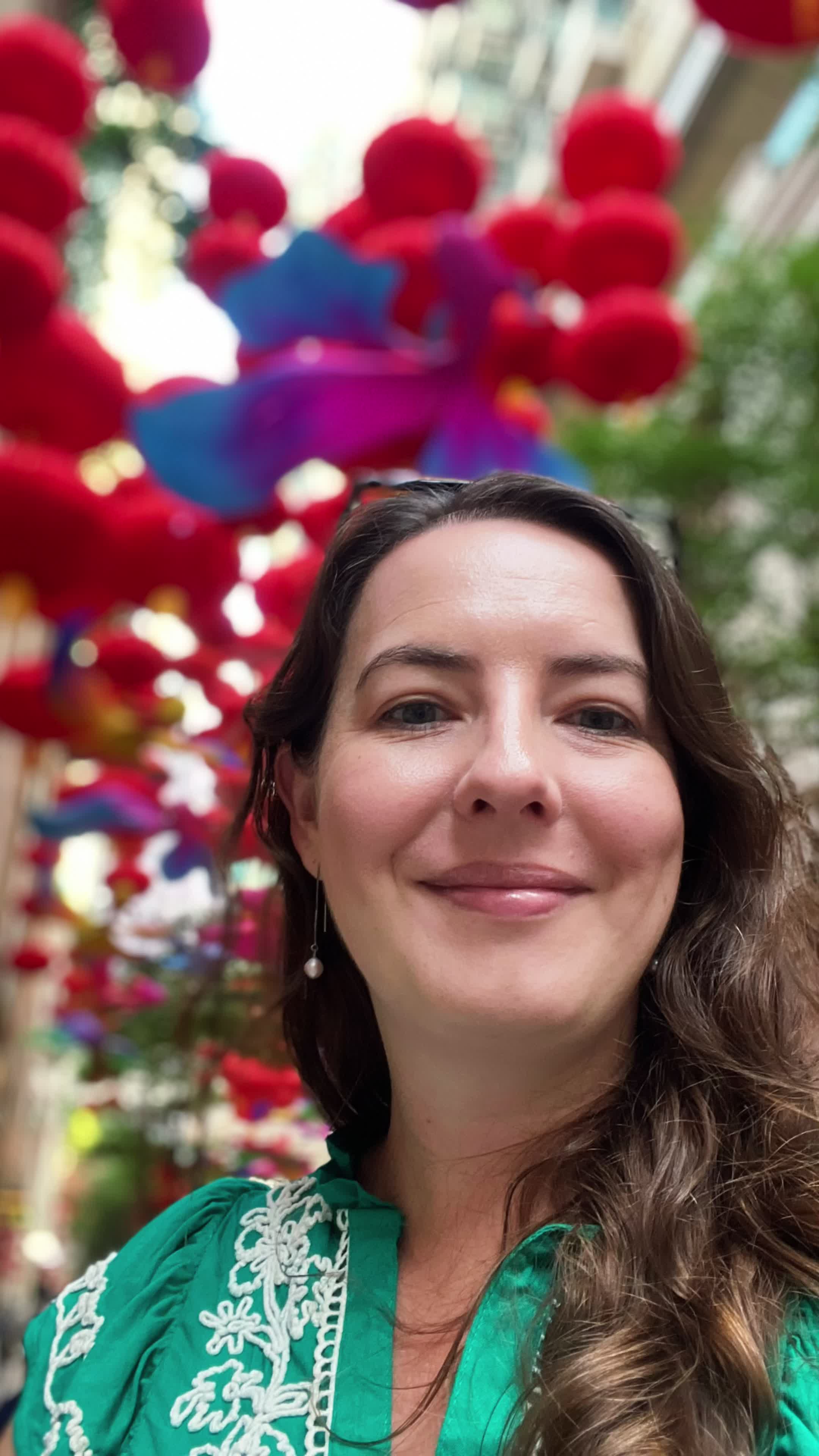 Photo of Dr Hannah on Tung Chung Avenue with red lanterns behind her